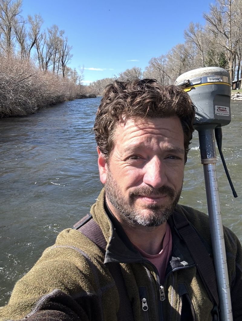 Jeremiah Harness, PLS, surveying along a river in Western Colorado